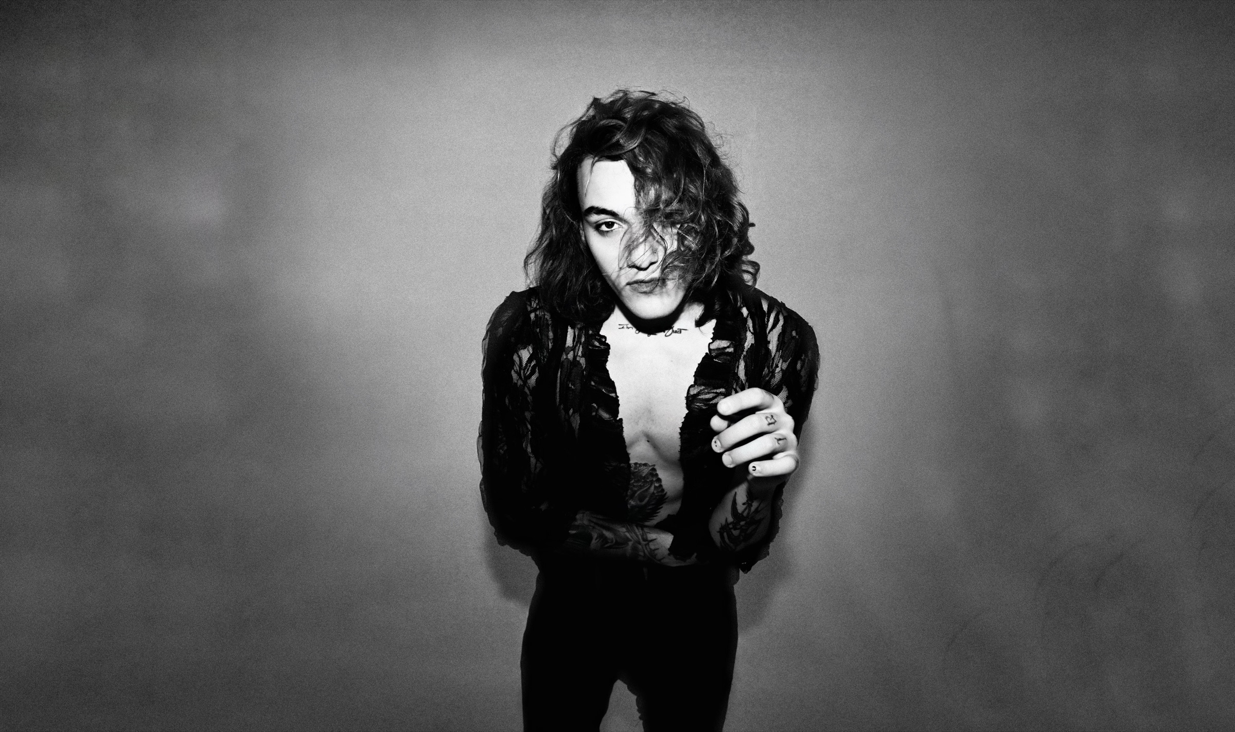 Brooklin Rich in a black-and-white portrait against a grey wall